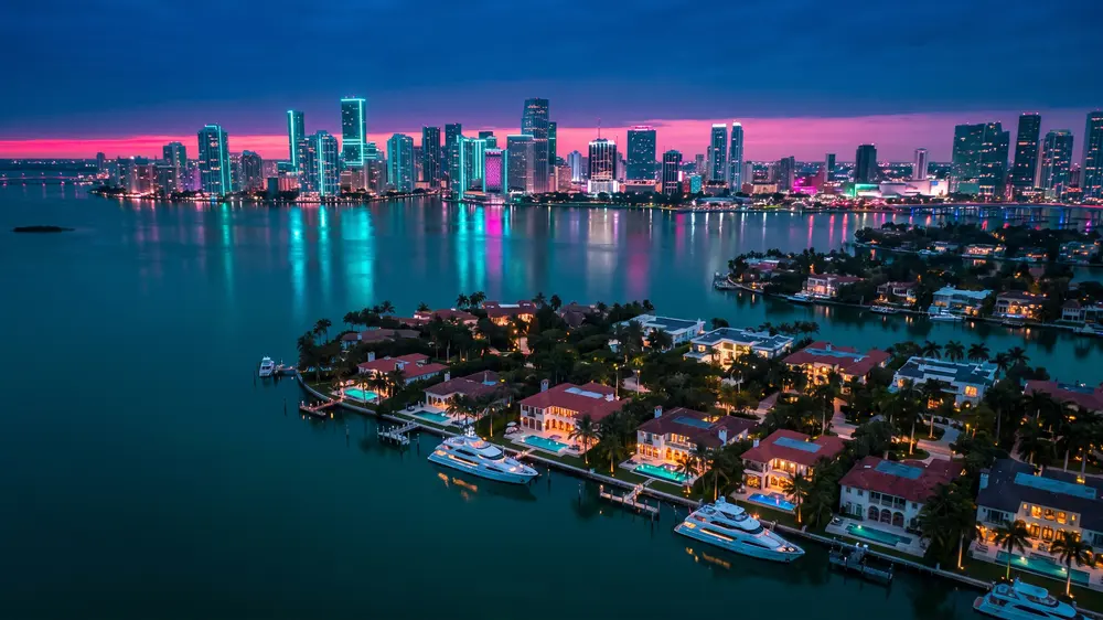 Star Island and the Venetian Islands at dusk, downtown Miami glowing beyond.